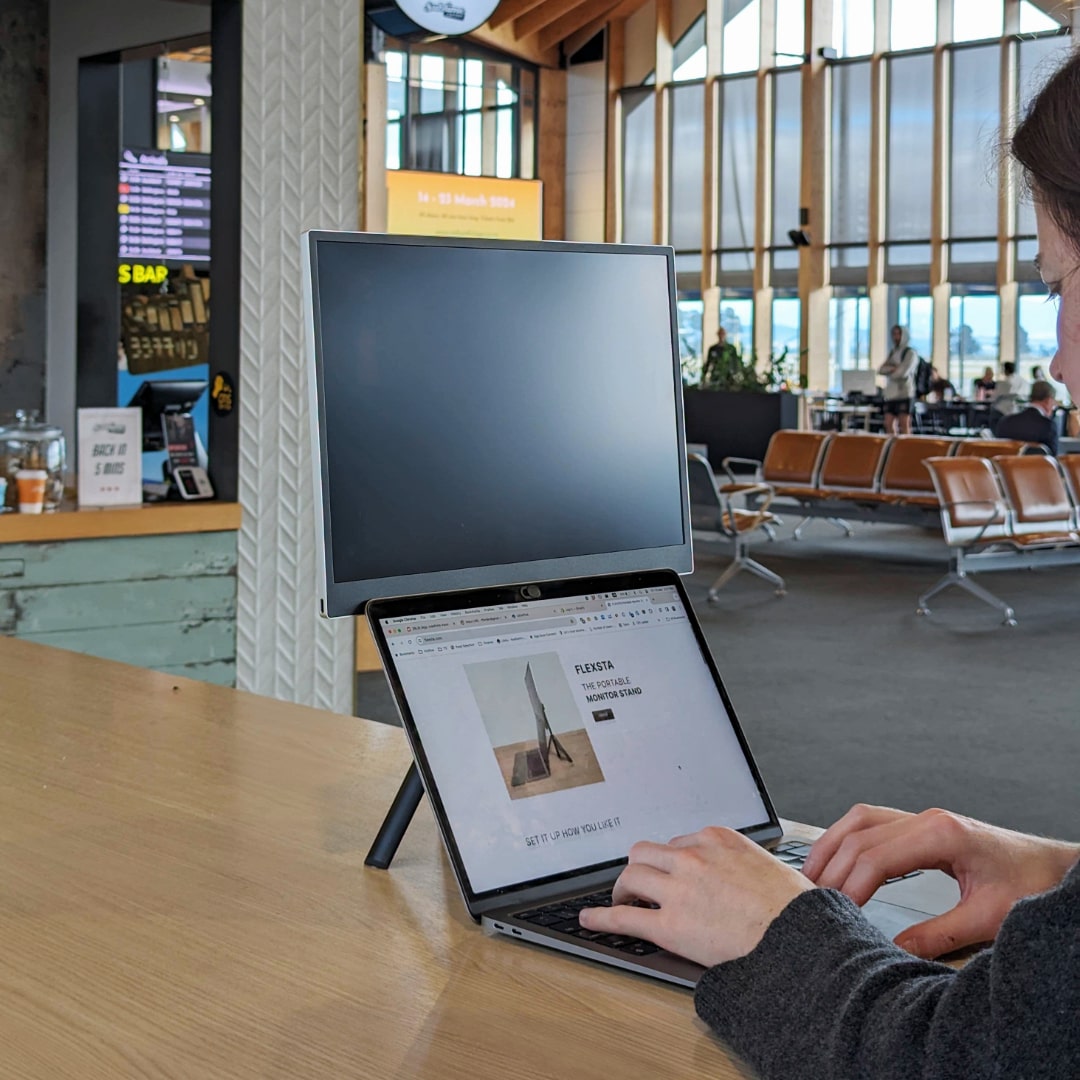 flexsta portable monitor stand being used in airport